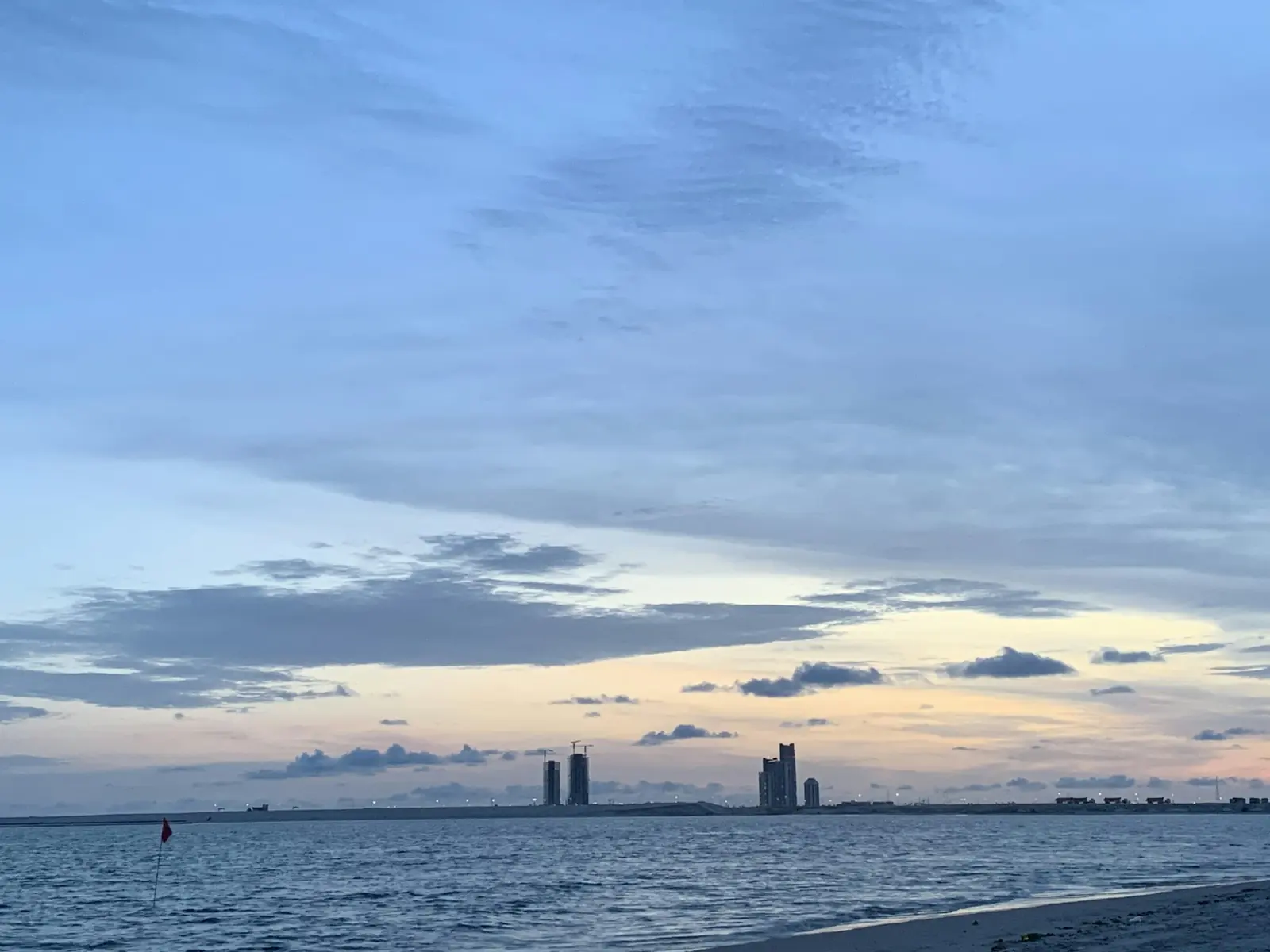 Oniru Beach at twilight with the Lagos skyline across the water